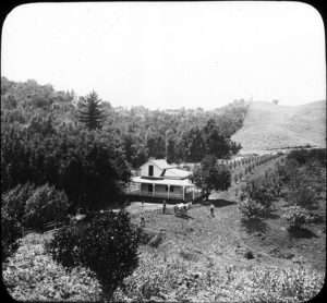 A black and white photo from the 1930s showing a white farmhouse next to open land and forest in the Willamette Valley, Oregon for article on environmental generational amnesia